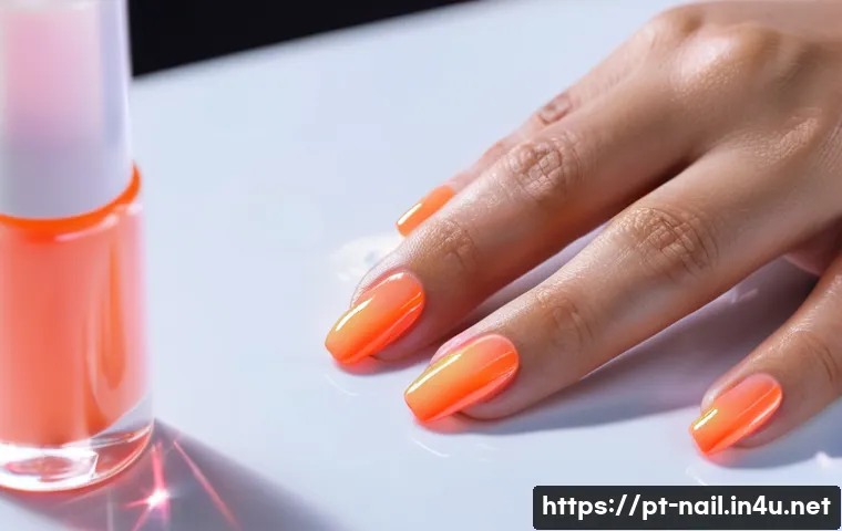 젤 네일 탑코트 고르는 법 - A close-up image of a professional manicure session focusing on applying a glossy gel top coat on we...